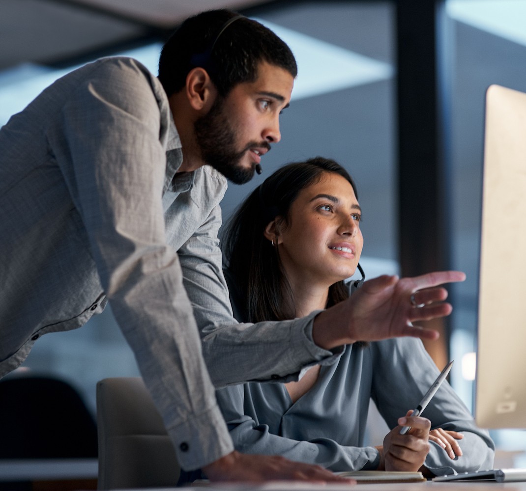 Customer care team reviewing information on a computer