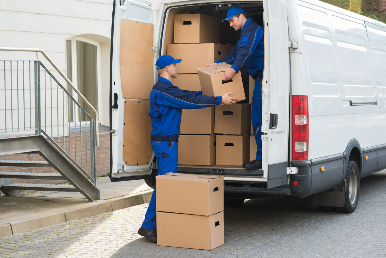 Workers loading boxes into a delivery van
